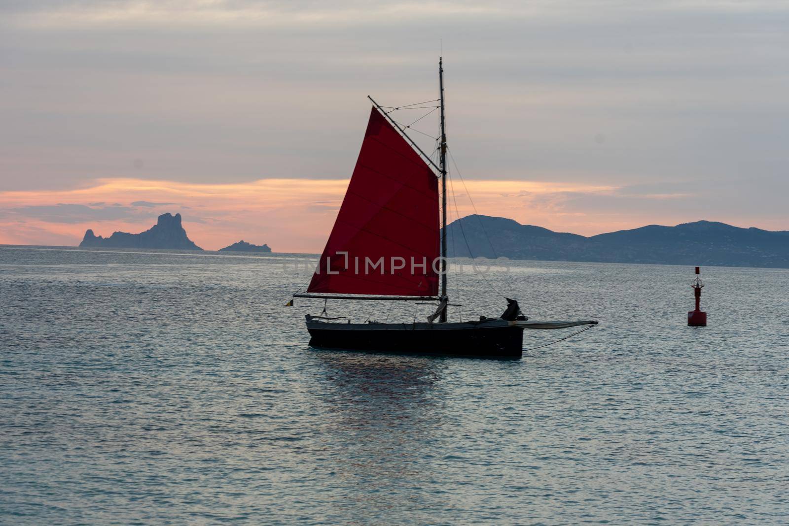 Sailing boat on the Island of Formentera in the summer of 2021 with Es Vedra behind.