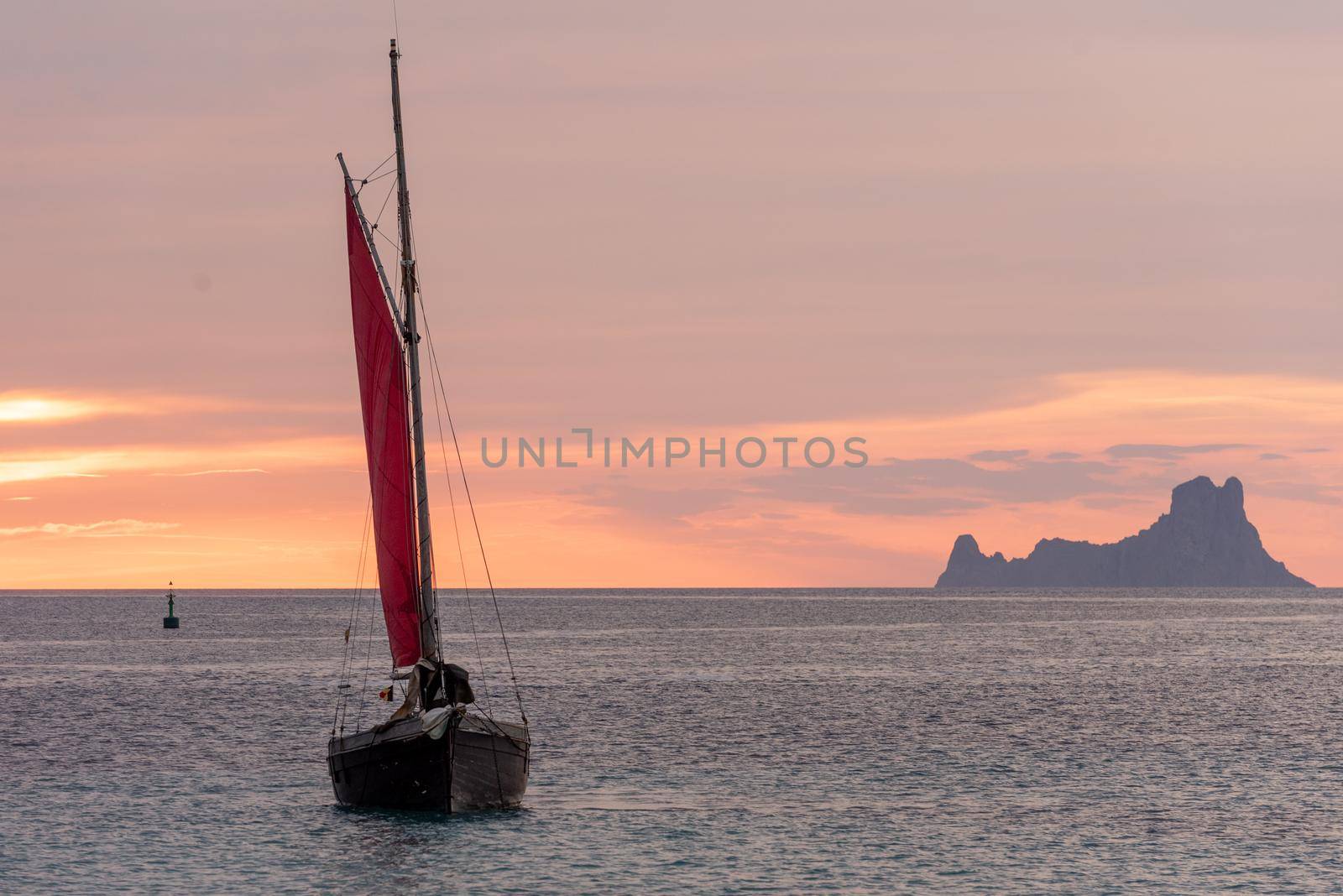 Sailing boat on the Island of Formentera in the summer of 2021 with Es Vedra behind.