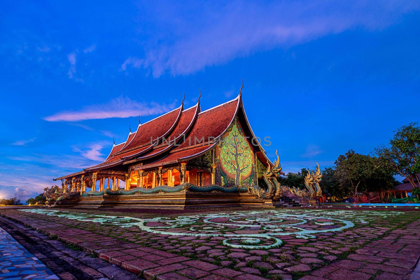 Twilight shot of Sirindhorn Wararam Phu Prao Temple is public Temple in Ubonrachatani, Thailand. by NuwatPhoto