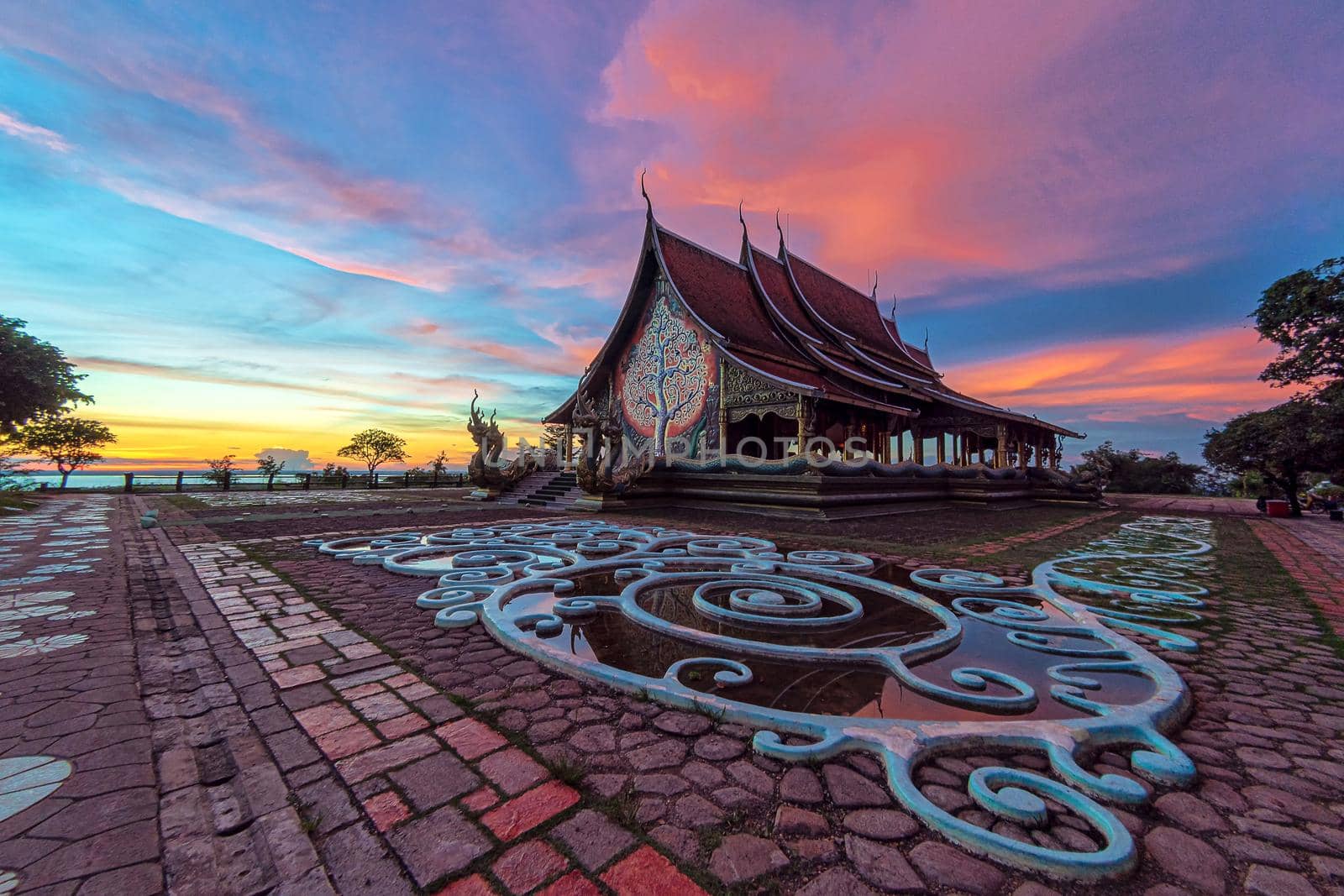 Twilight shot of Sirindhorn Wararam Phu Prao Temple is public Temple in Ubonrachatani, Thailand. Popularly known as the luminous temple Very Beautiful attractions.