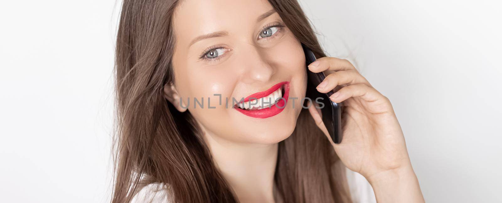 Happy smiling woman calling on smartphone, portrait on white background. People, technology and communication concept.