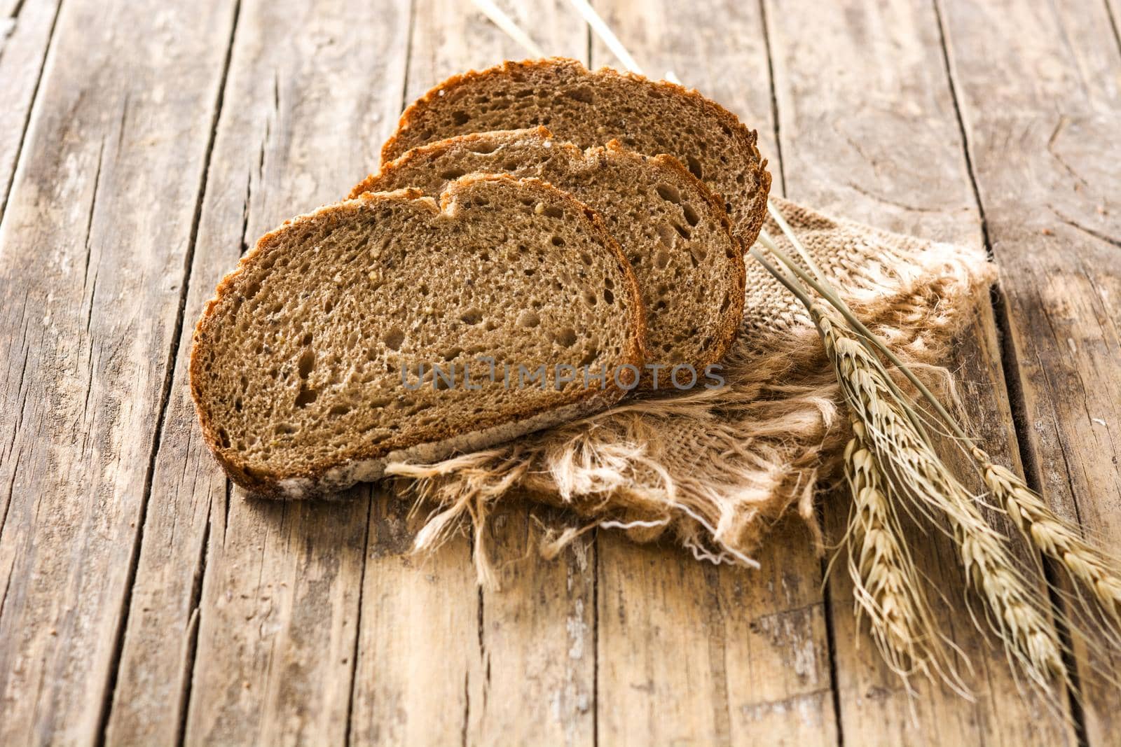 Fresh rye bread on wooden table