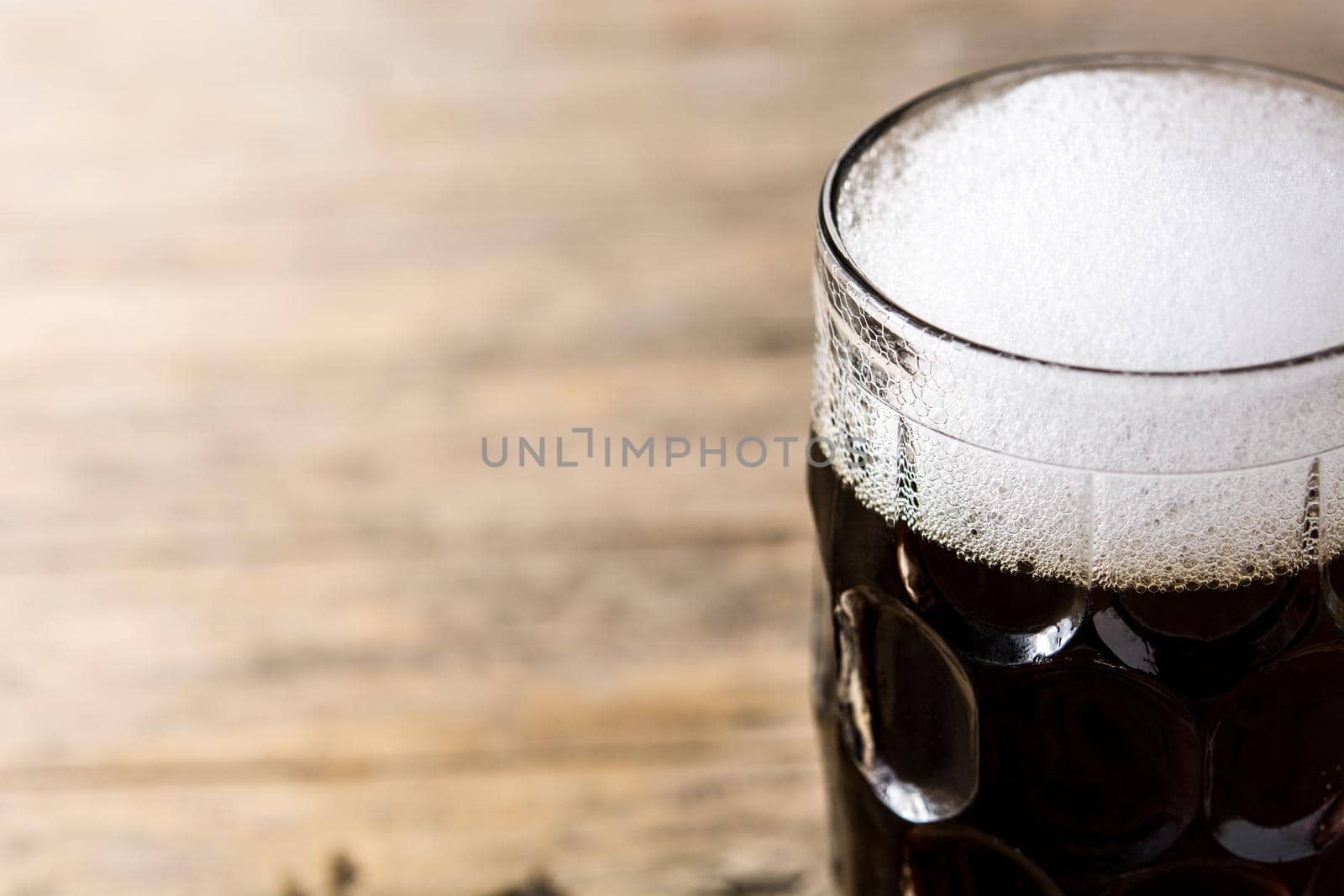 Traditional kvass beer mug with rye bread on wooden table