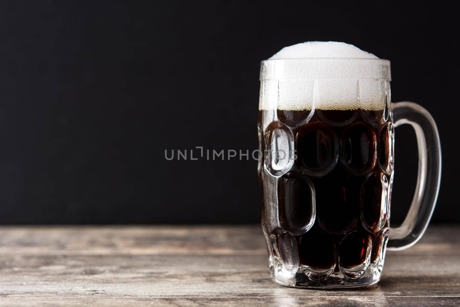 Traditional kvass beer mug with rye bread on wooden table