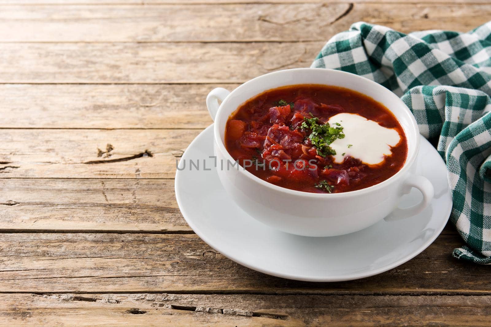 Traditional Ukrainian Russian borsch. Beetroot soup on wooden table