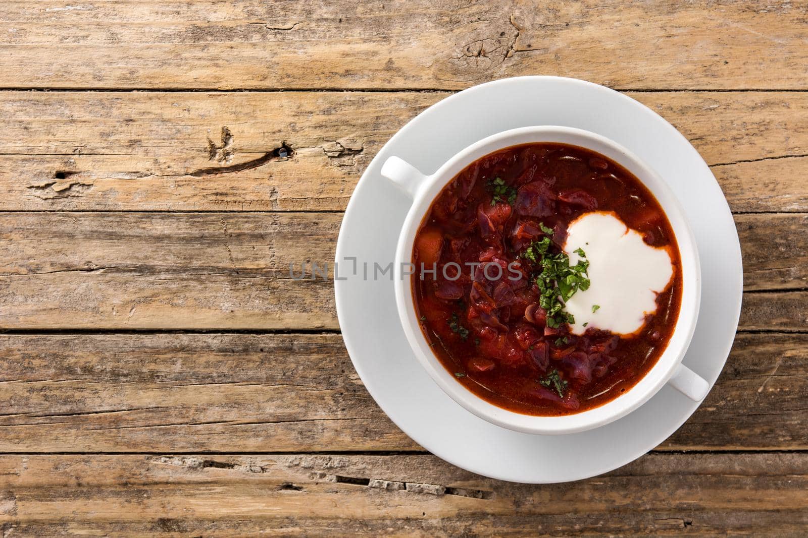 Traditional Ukrainian Russian borsch. Beetroot soup on wooden table