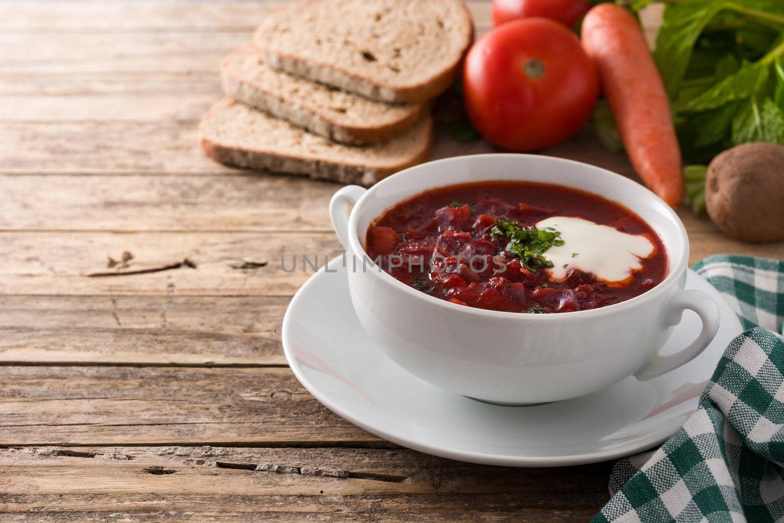 Traditional Ukrainian Russian borsch. Beetroot soup on wooden table