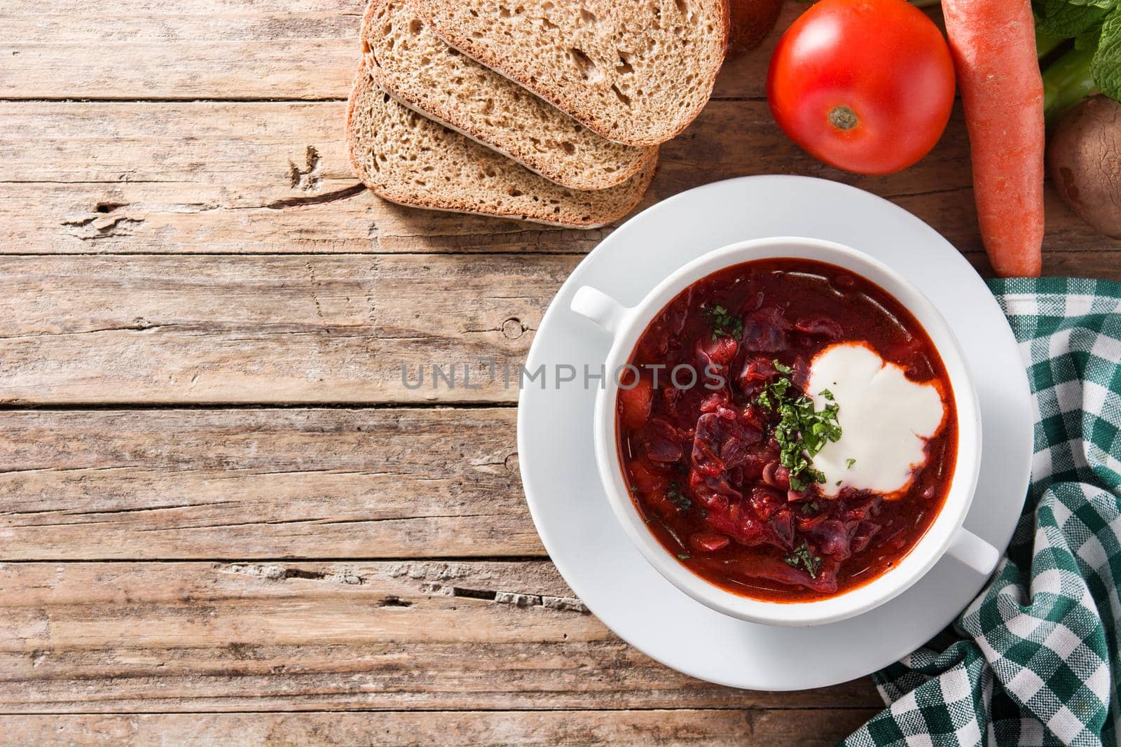 Traditional Ukrainian Russian borsch. Beetroot soup on wooden table