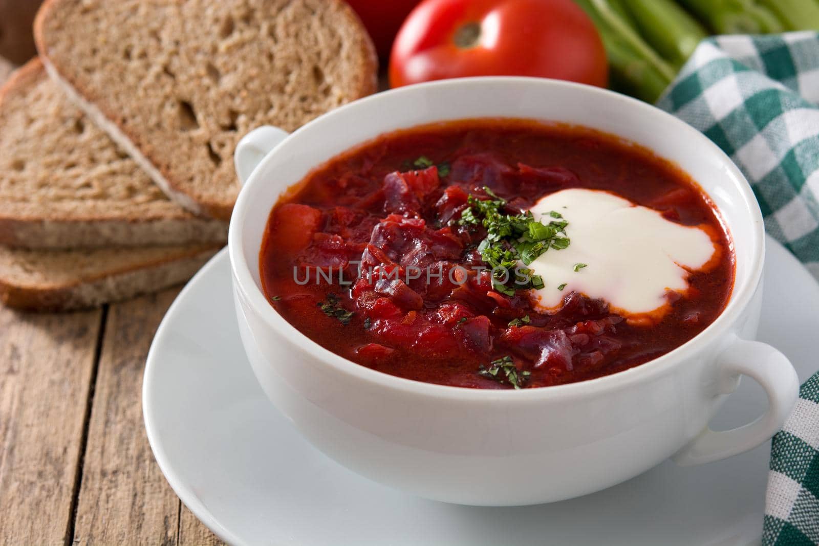 Traditional Ukrainian Russian borsch. Beetroot soup on wooden table