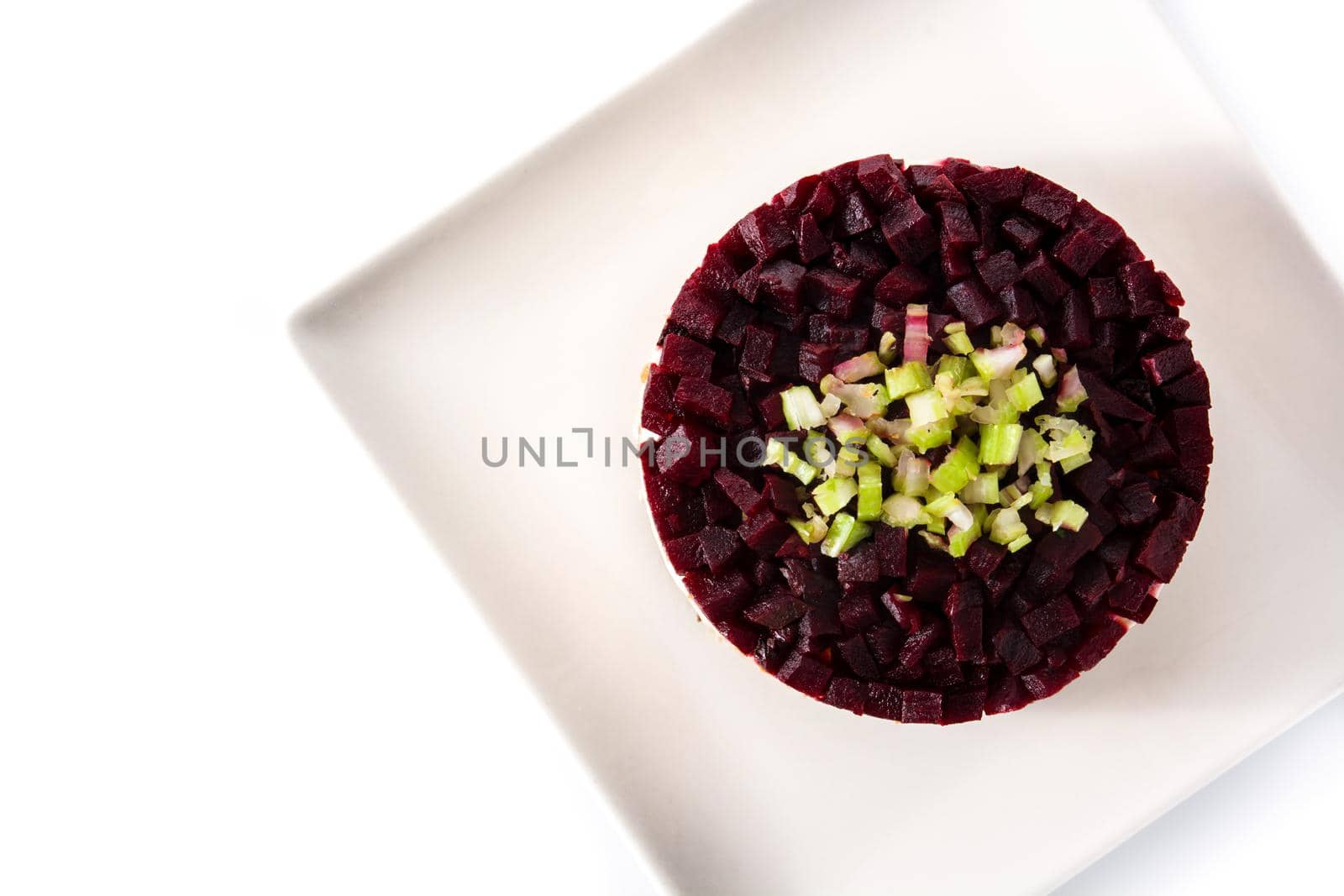 Traditional Russian herring salad with beetroot and carrots isolated on white background