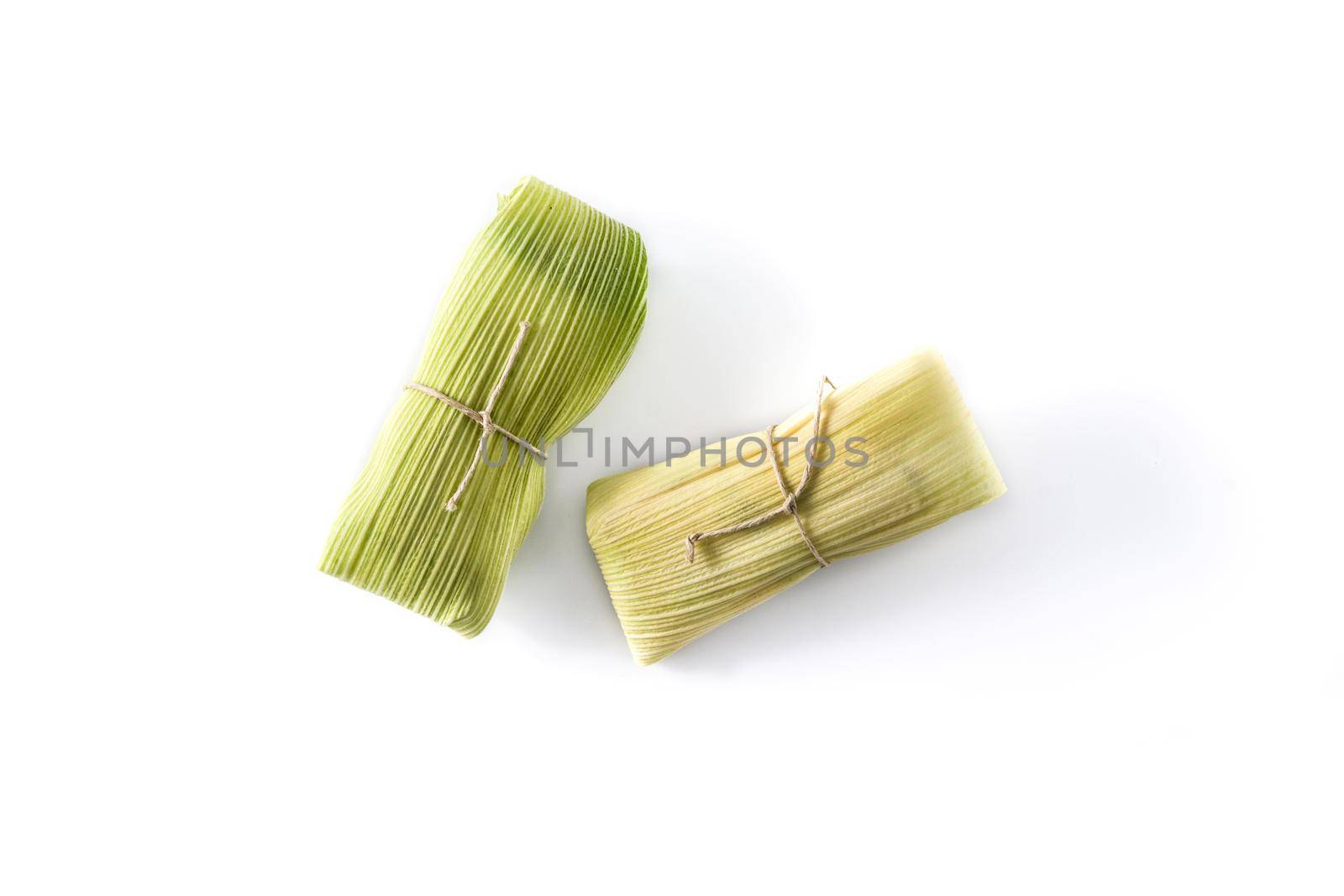 Mexican corn and chicken tamales isolated on white background.