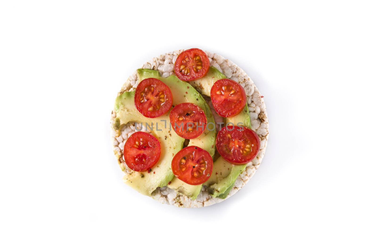 Puffed rice cake with tomatoes and avocado isolated on white background