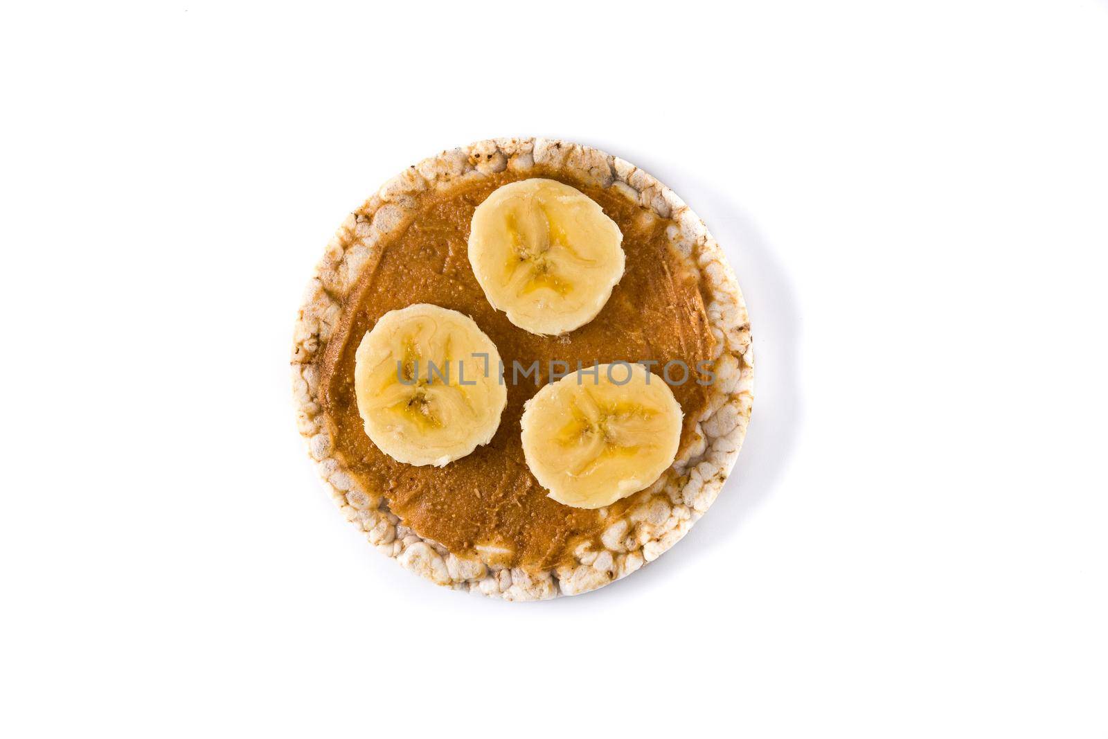 Puffed rice cake with banana and peanut butter isolated on white background