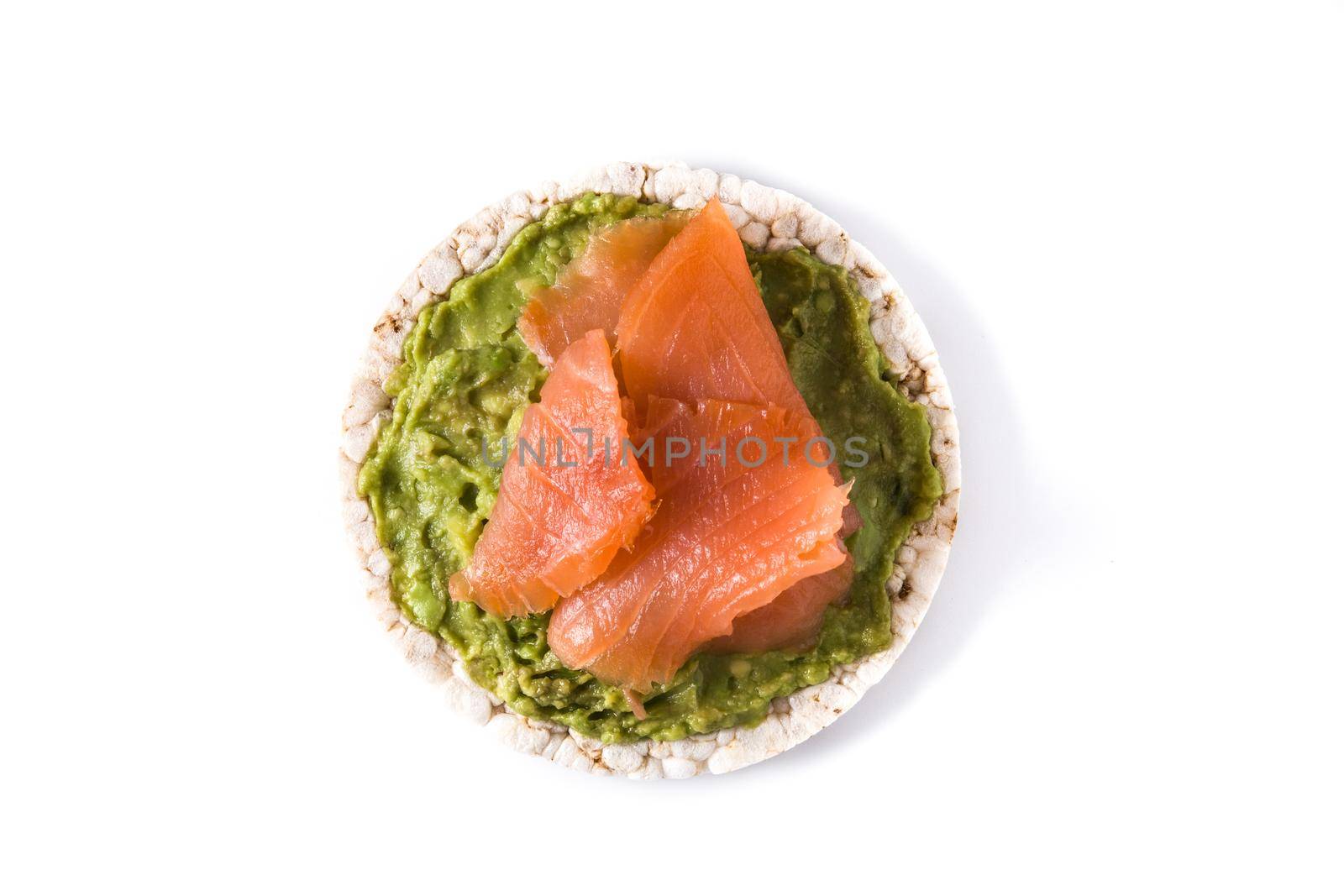 Puffed rice cake with guacamole and salmon isolated on white background