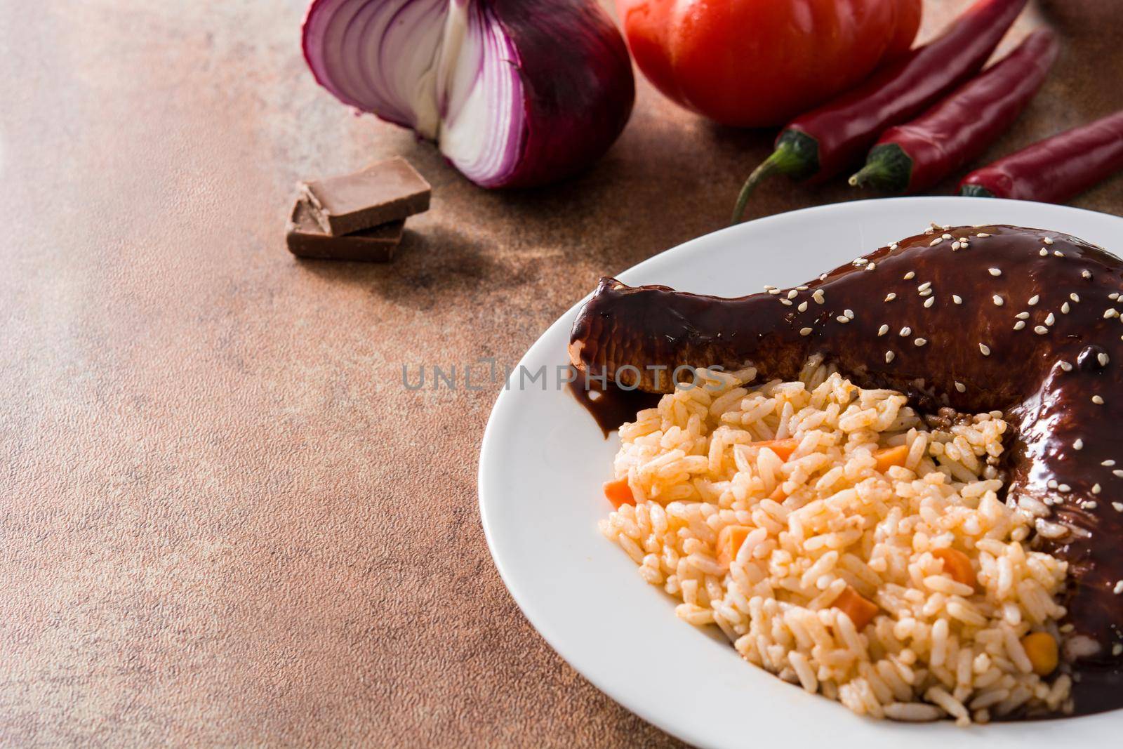 Traditional mole Poblano with rice plate on rusty surface