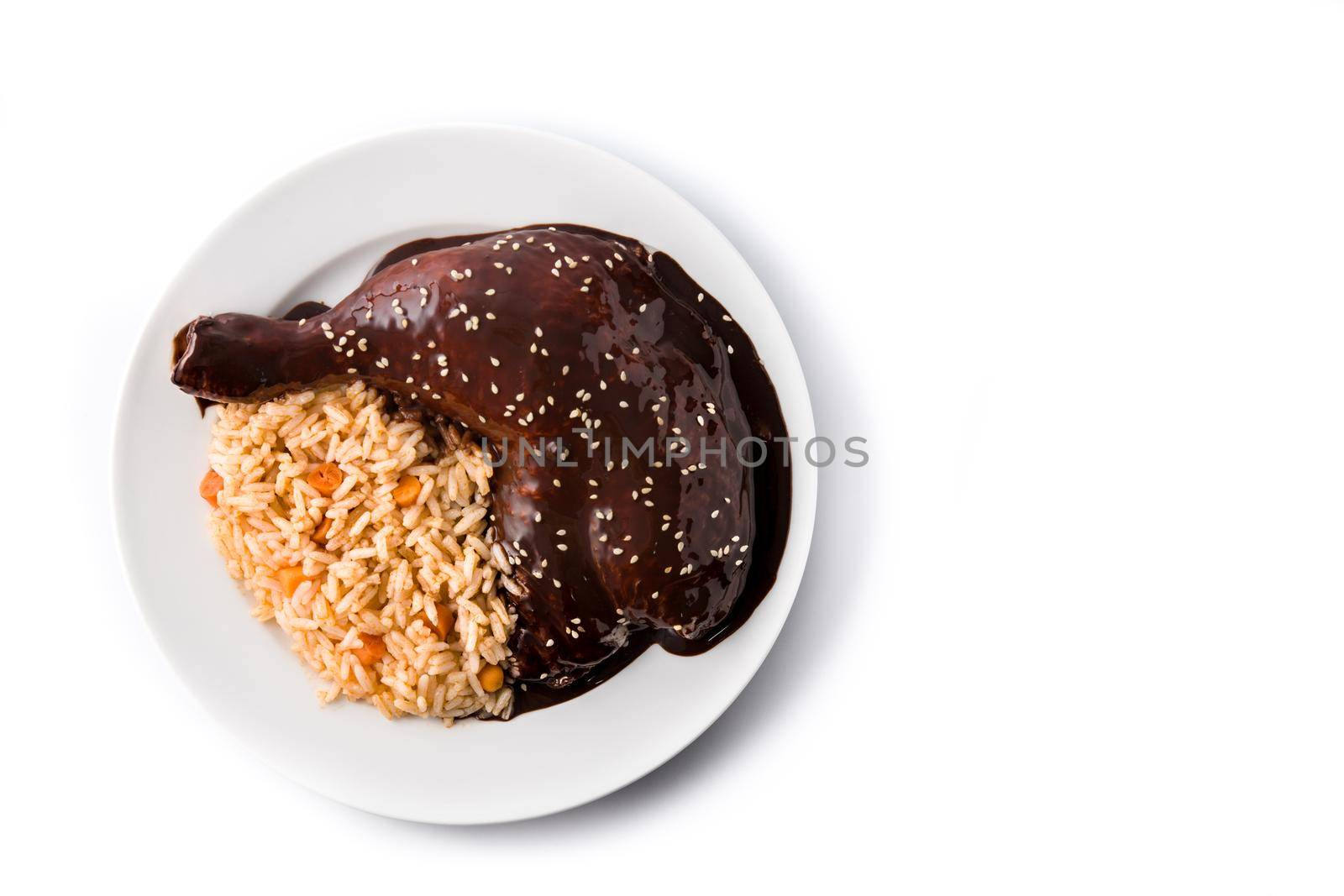 Traditional mole Poblano with rice in plate isolated on white background.