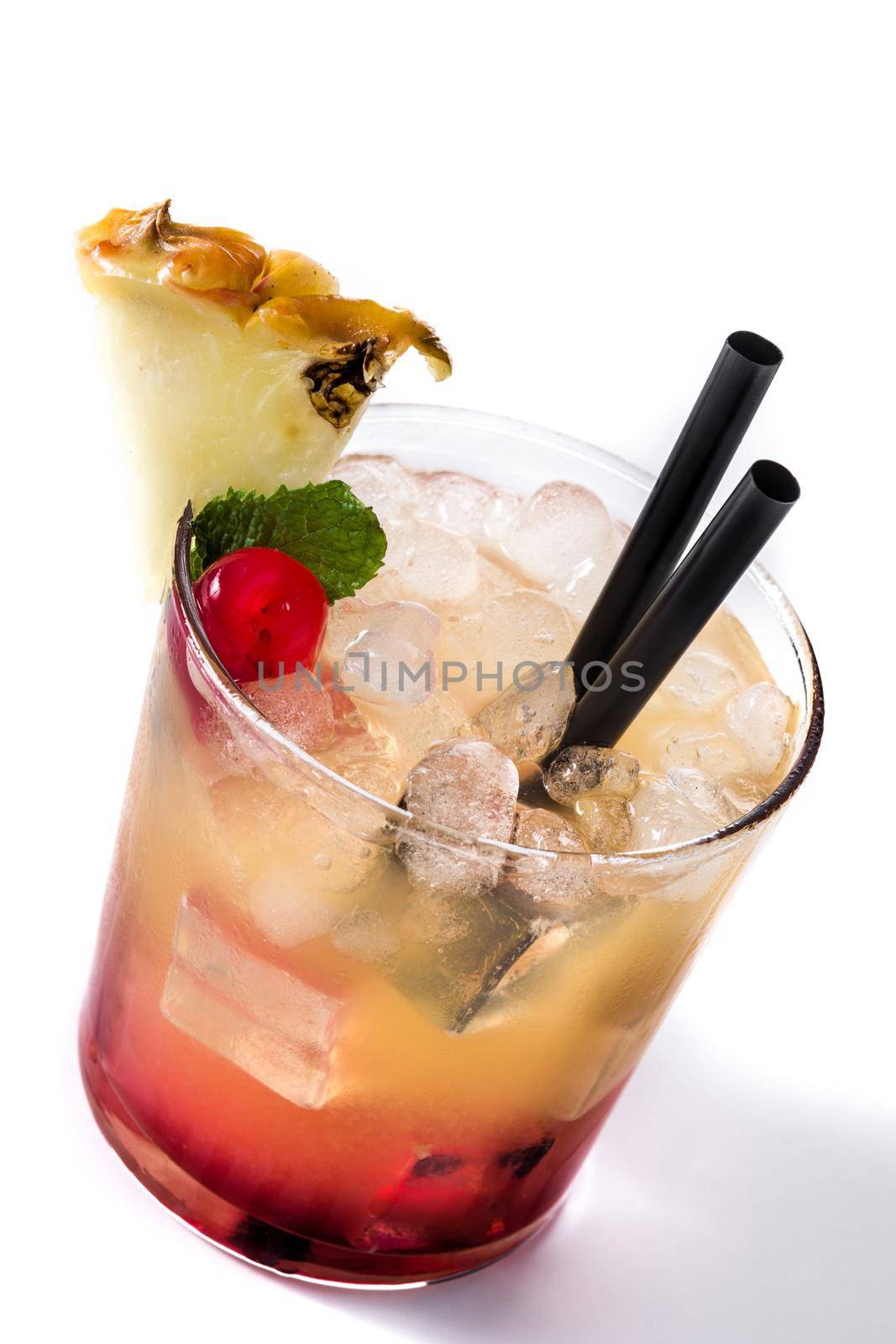 Cold mai tai cocktail with pineapple and cherry isolated on white background.
