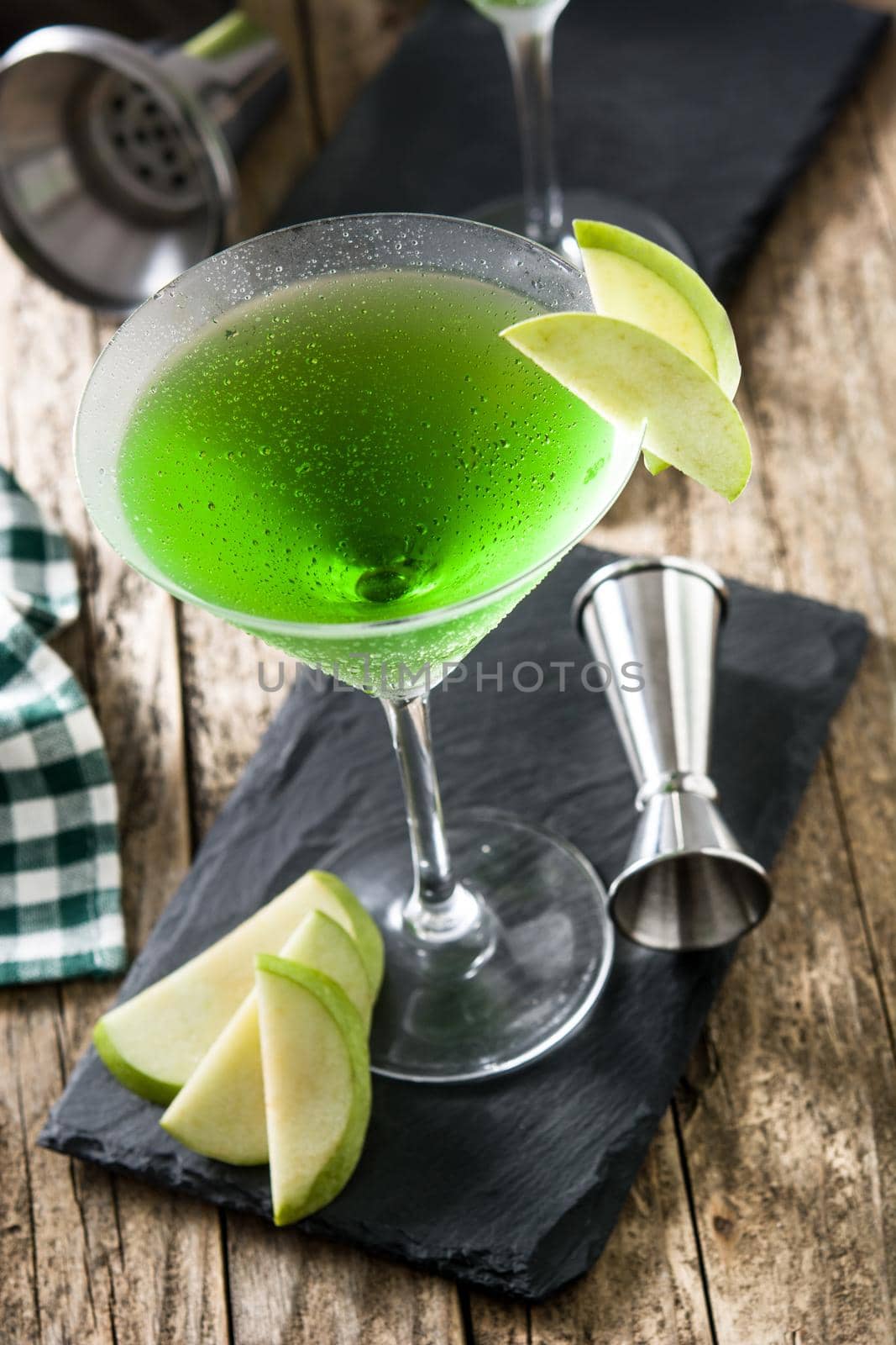 Green appletini cocktail on wooden table