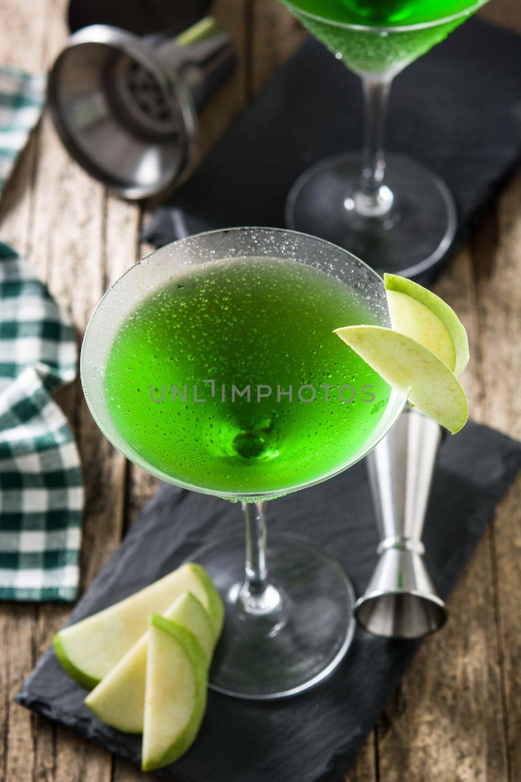 Green appletini cocktail on wooden table