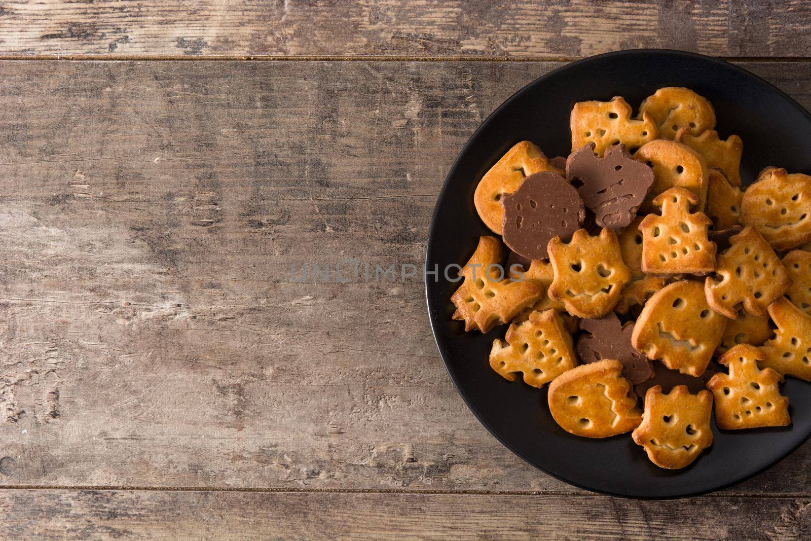 Funny Halloween cookies on wooden table