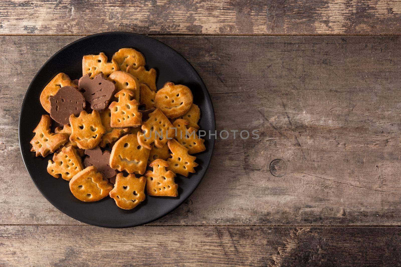 Funny Halloween cookies on wooden table