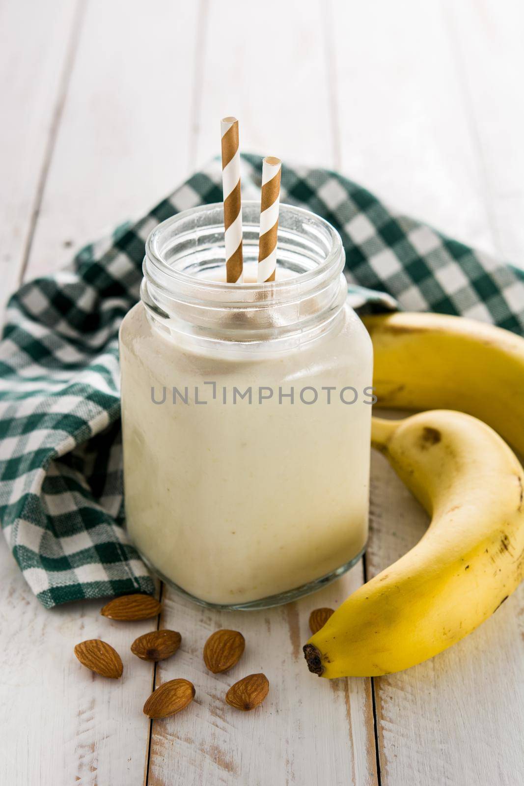 Banana smoothie with almond in jar  by chandlervid85