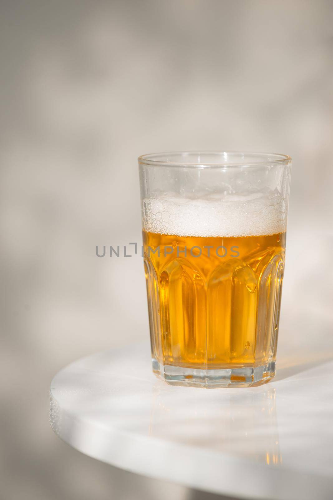 A glass of beer on the table.