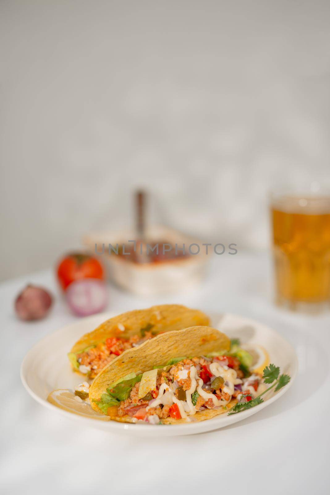 Authentic mexican tacos with beer. Mexican tacos with ground meat, beef, beans, onions and salsa