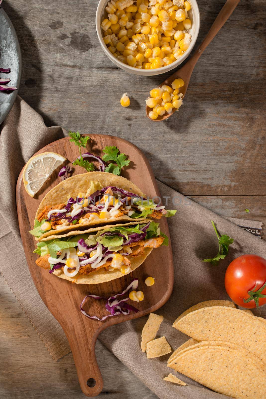 Traditional mexican taco with chicken and vegetables on wooden table. Latin american food. 