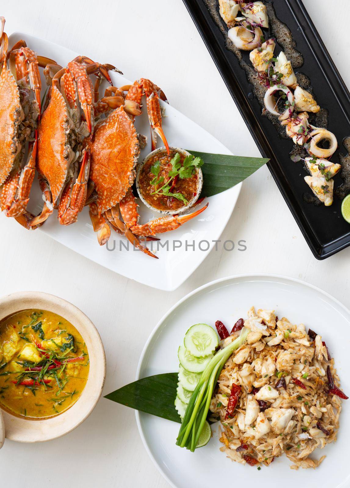 Set of Thai seafood popular menu setting on white table. by Benzoix