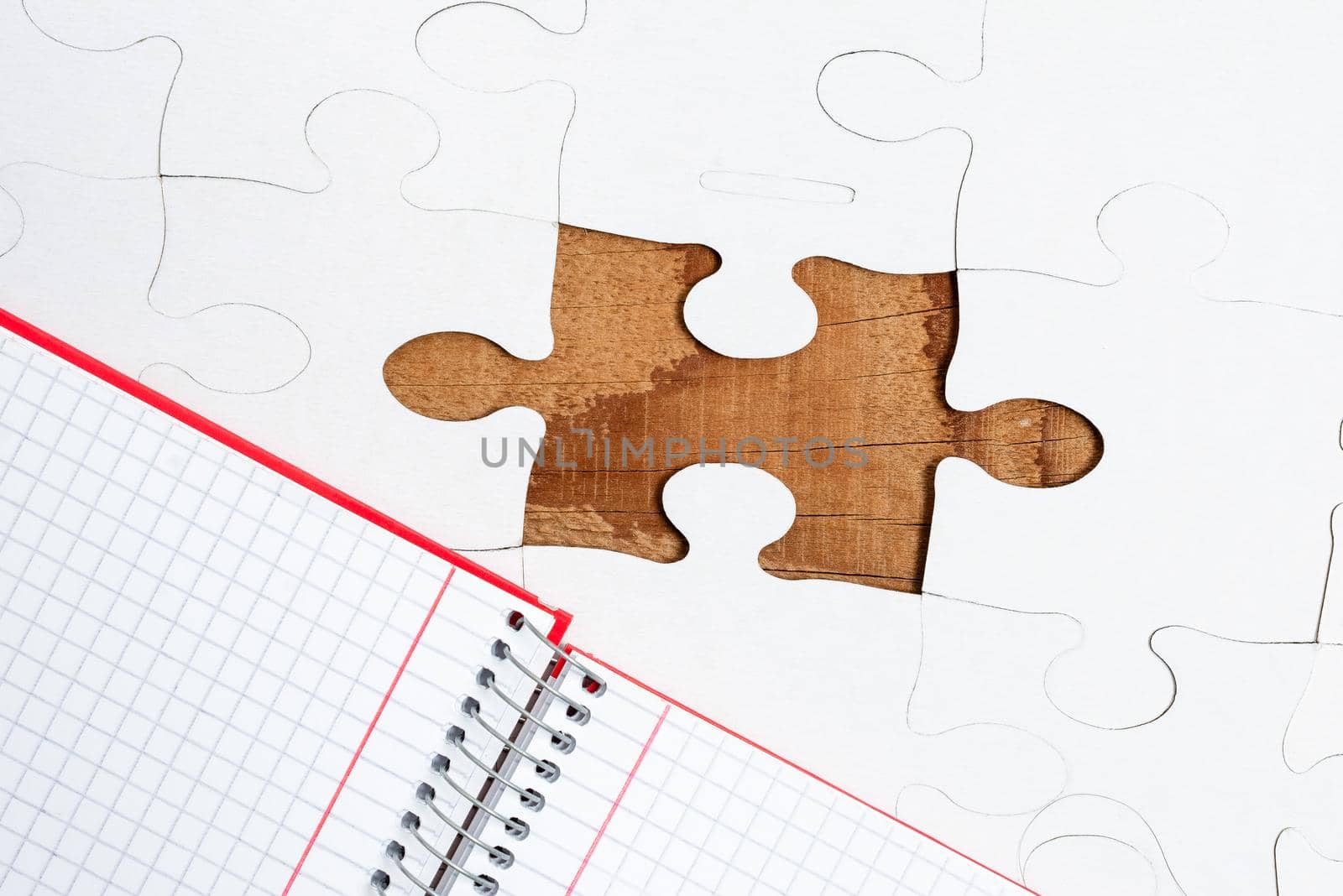 Building An Unfinished White Jigsaw Pattern Puzzle With Missing Last Piece