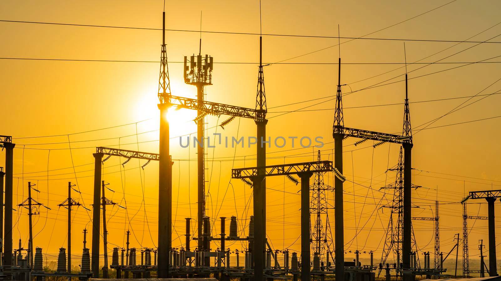 Production of fuel and electricity.Electrical networks with wires and transformers at sunset.Power transmission lines and from the power plant.Power lines with wires under voltage and electric current by YevgeniySam