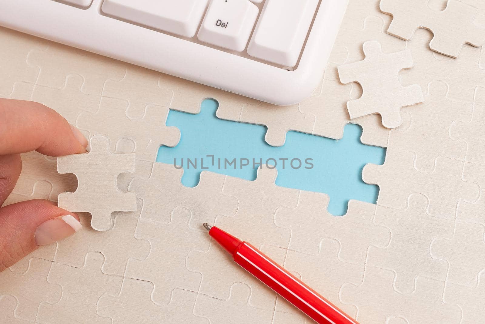 Building An Unfinished White Jigsaw Pattern Puzzle With Missing Last Piece