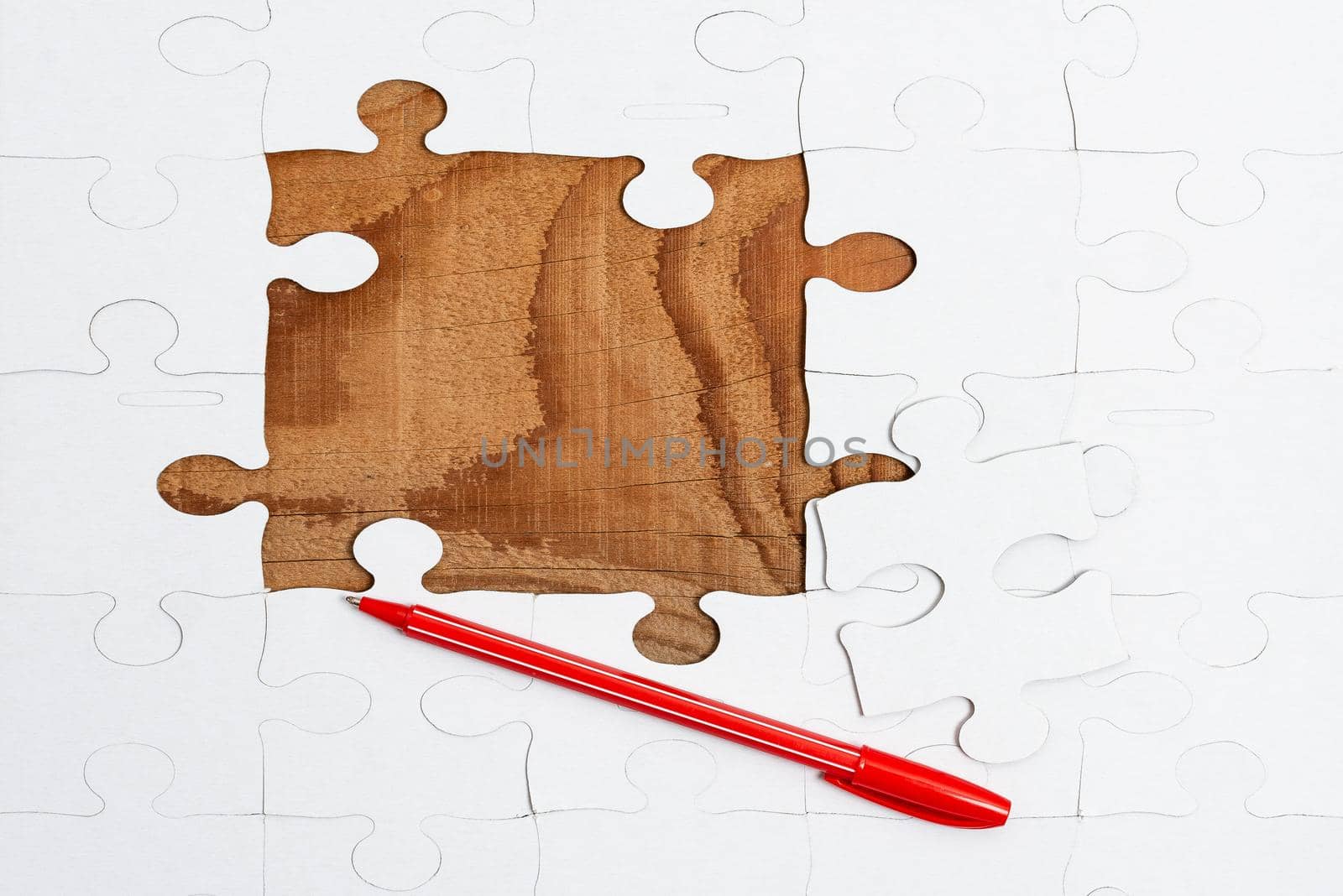 Building An Unfinished White Jigsaw Pattern Puzzle With Missing Last Piece