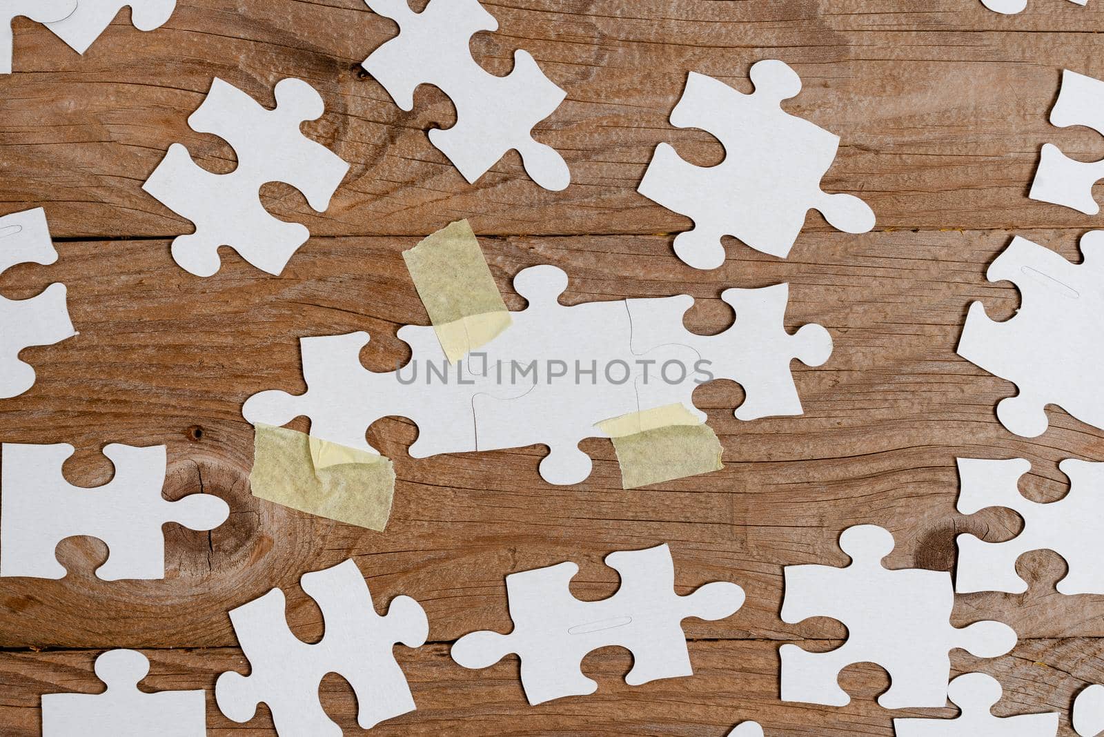 Building An Unfinished White Jigsaw Pattern Puzzle With Missing Last Piece