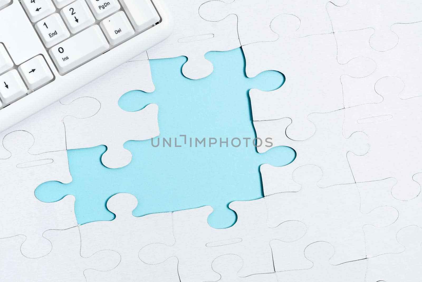 Building An Unfinished White Jigsaw Pattern Puzzle With Missing Last Piece