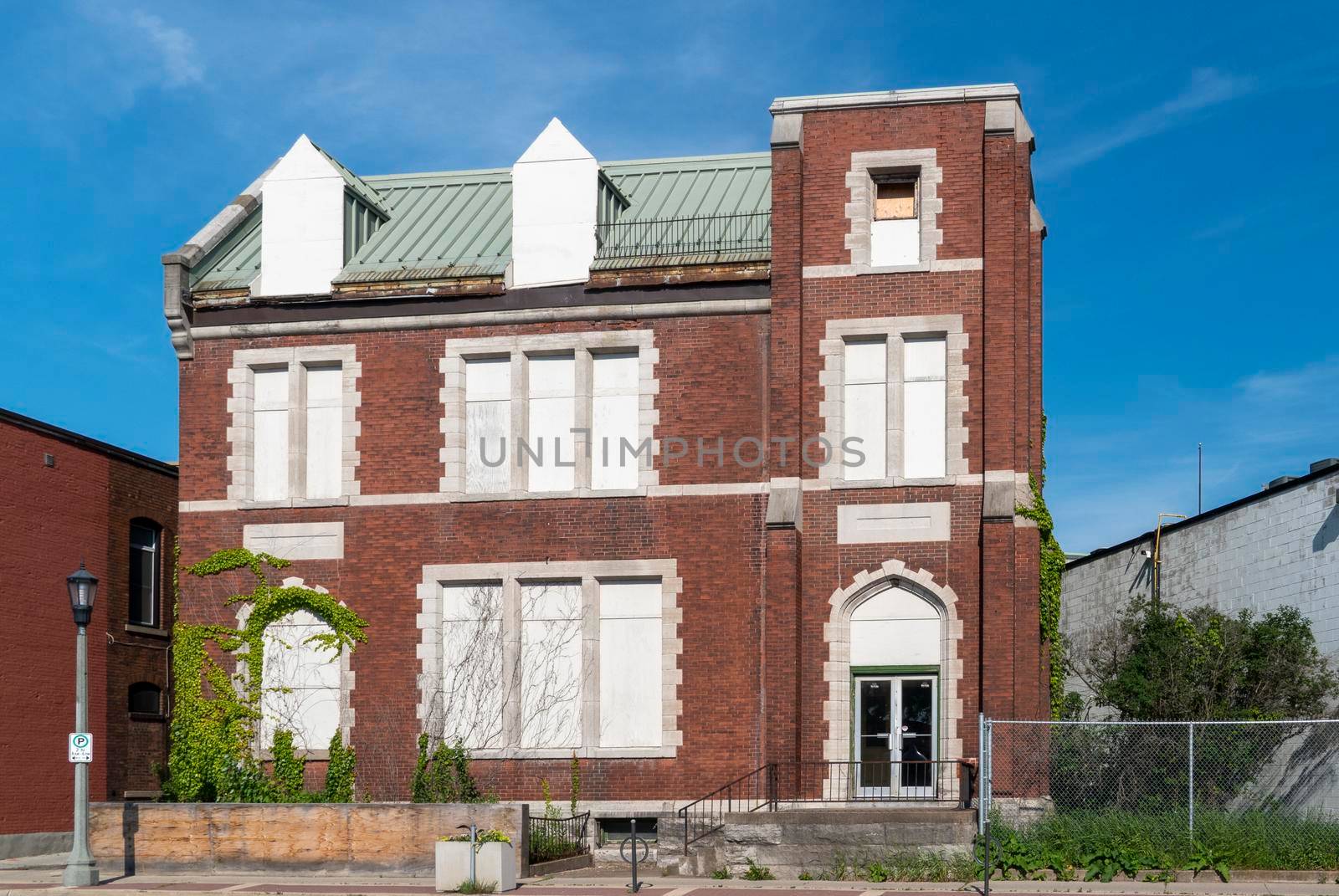 Old brick house with tightly closed windows on three floors