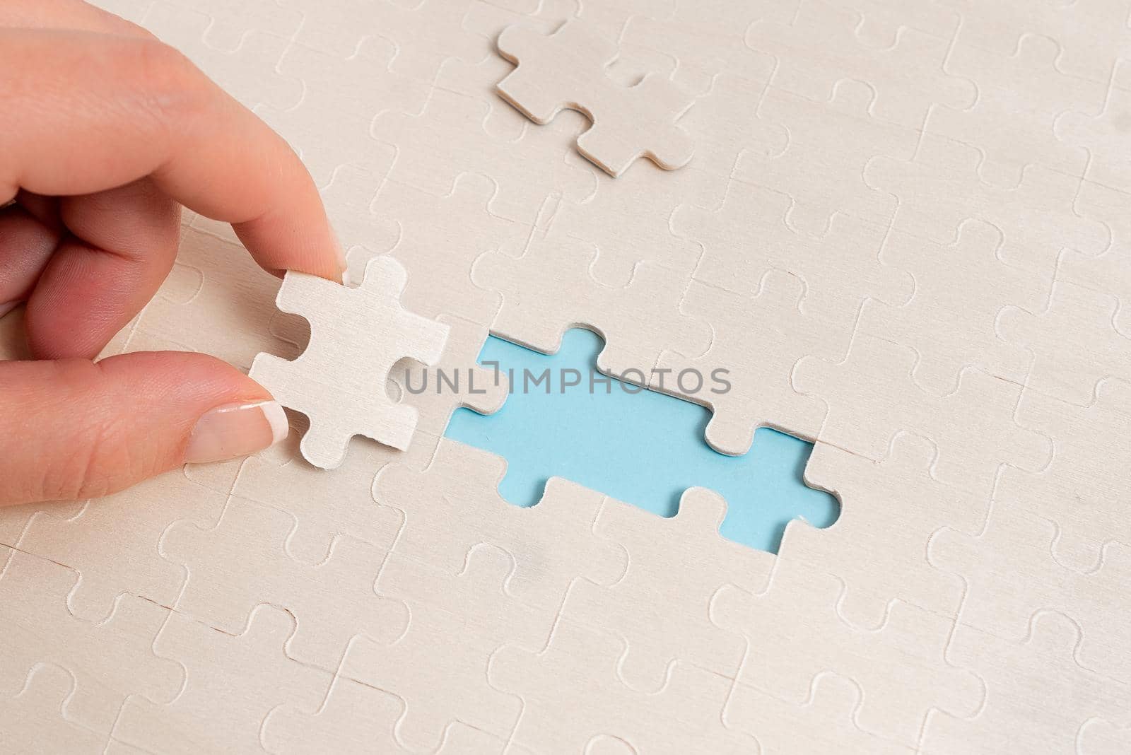 Building An Unfinished White Jigsaw Pattern Puzzle With Missing Last Piece