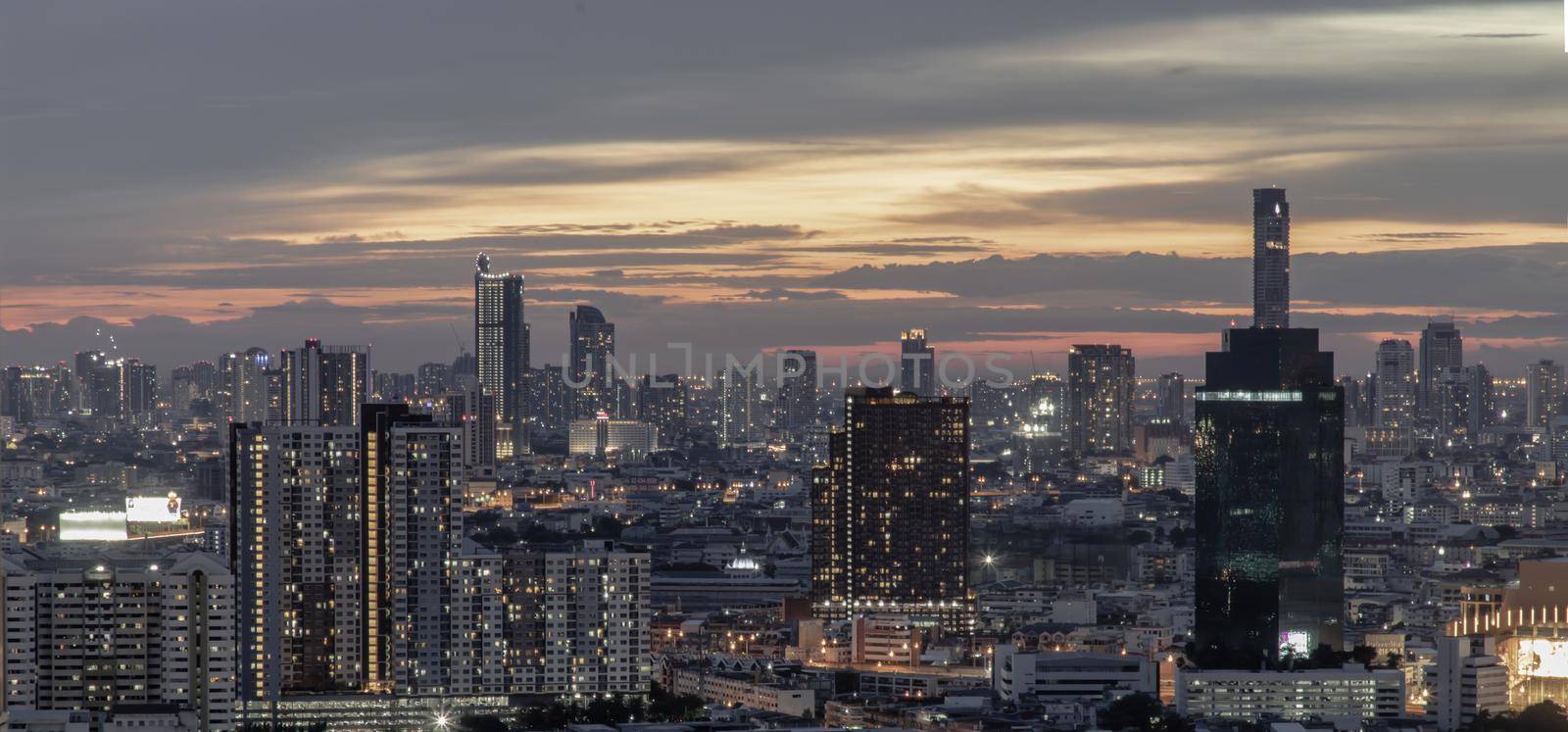 Bangkok, Thailand - Jun 05, 2021: Panorama shot of sunset at Bangkok city skyline. Beautiful scenery view of Skyscraper at night, Selective focus.