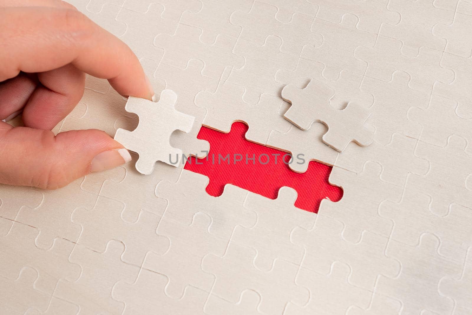 Building An Unfinished White Jigsaw Pattern Puzzle With Missing Last Piece