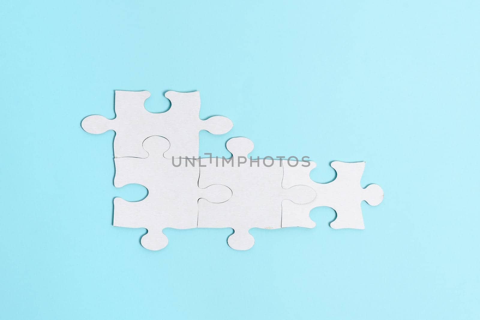 Building An Unfinished White Jigsaw Pattern Puzzle With Missing Last Piece