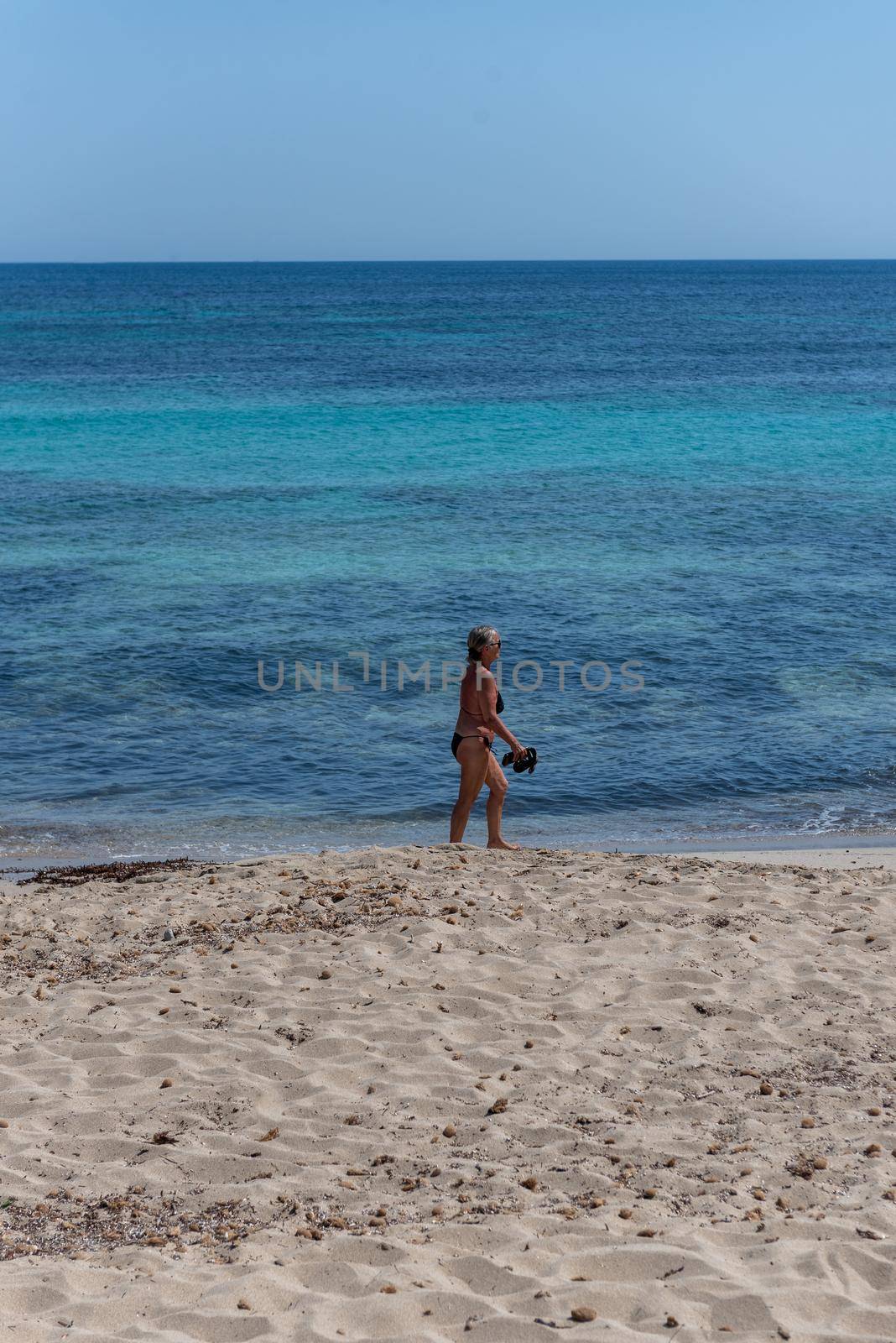 Formentera, Spain: June 12, 2021: People on Migjorn beach in Formentera in Spain in Times of COvid 19