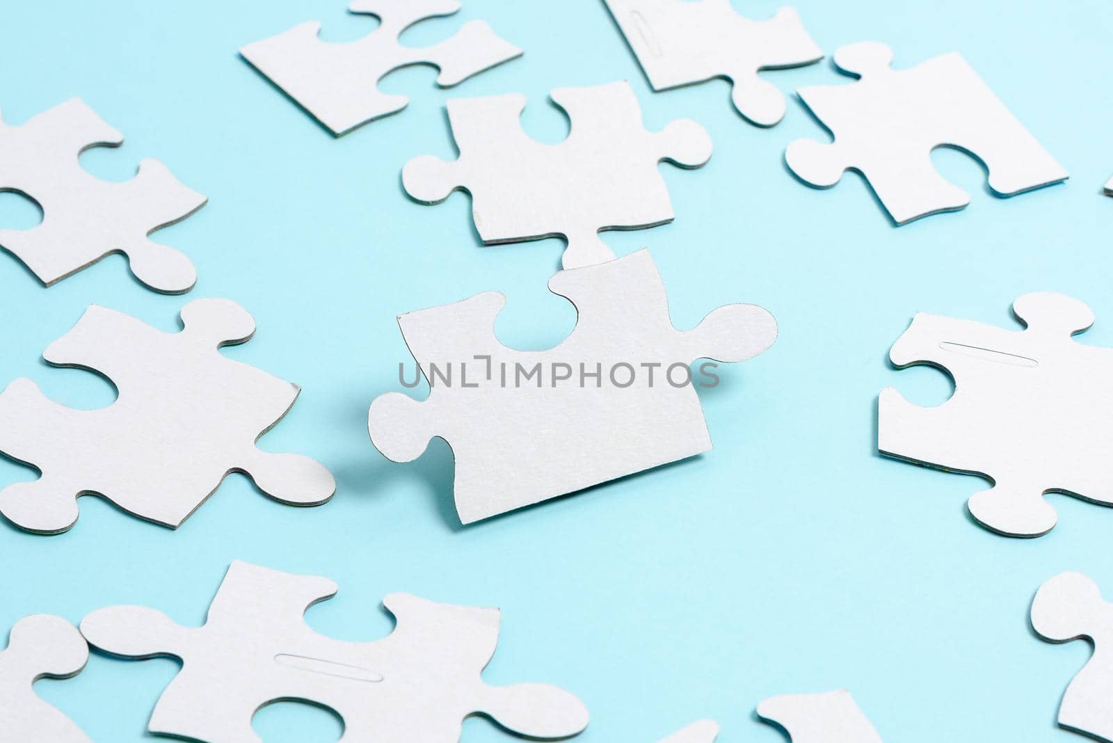 Building An Unfinished White Jigsaw Pattern Puzzle With Missing Last Piece