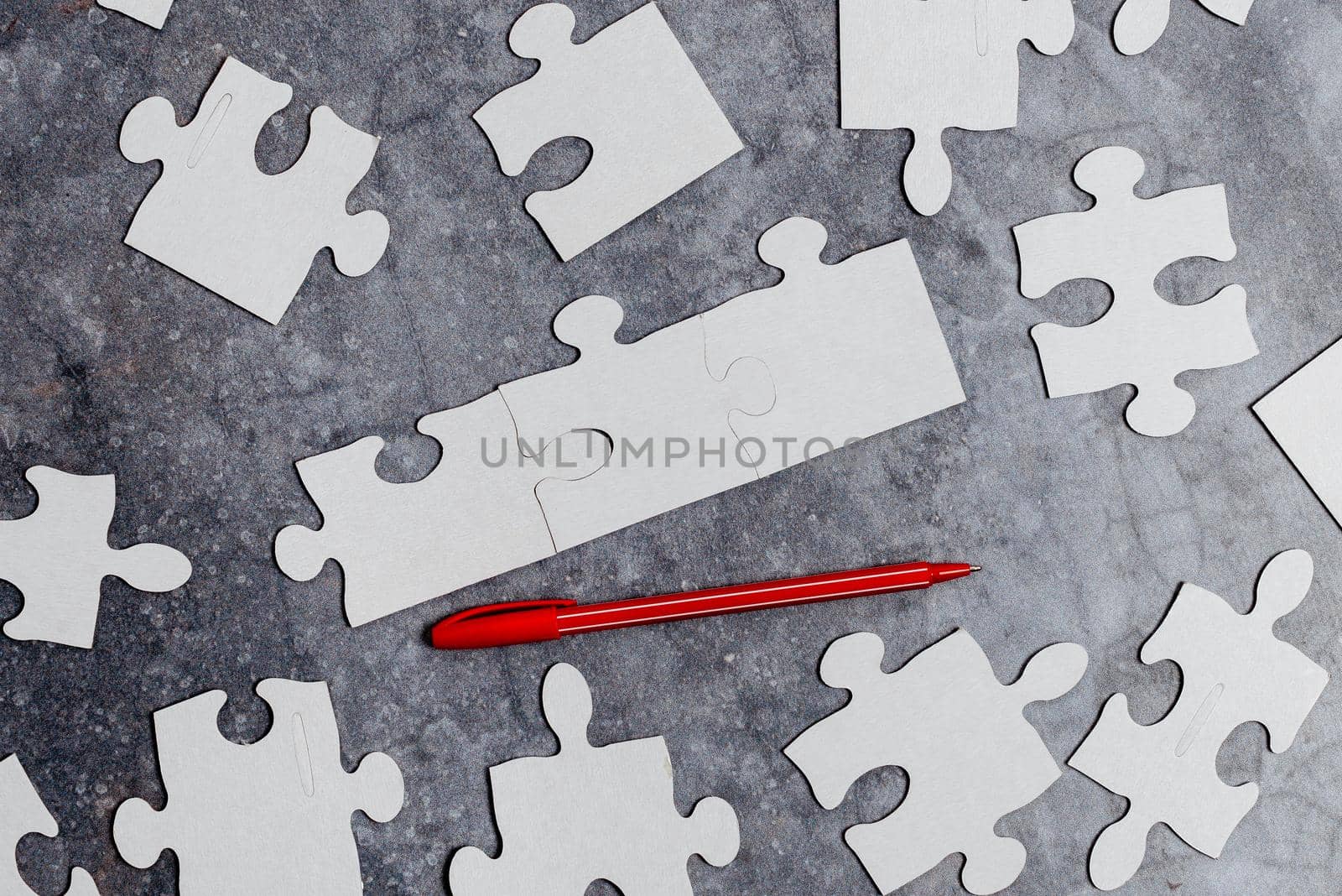Building An Unfinished White Jigsaw Pattern Puzzle With Missing Last Piece