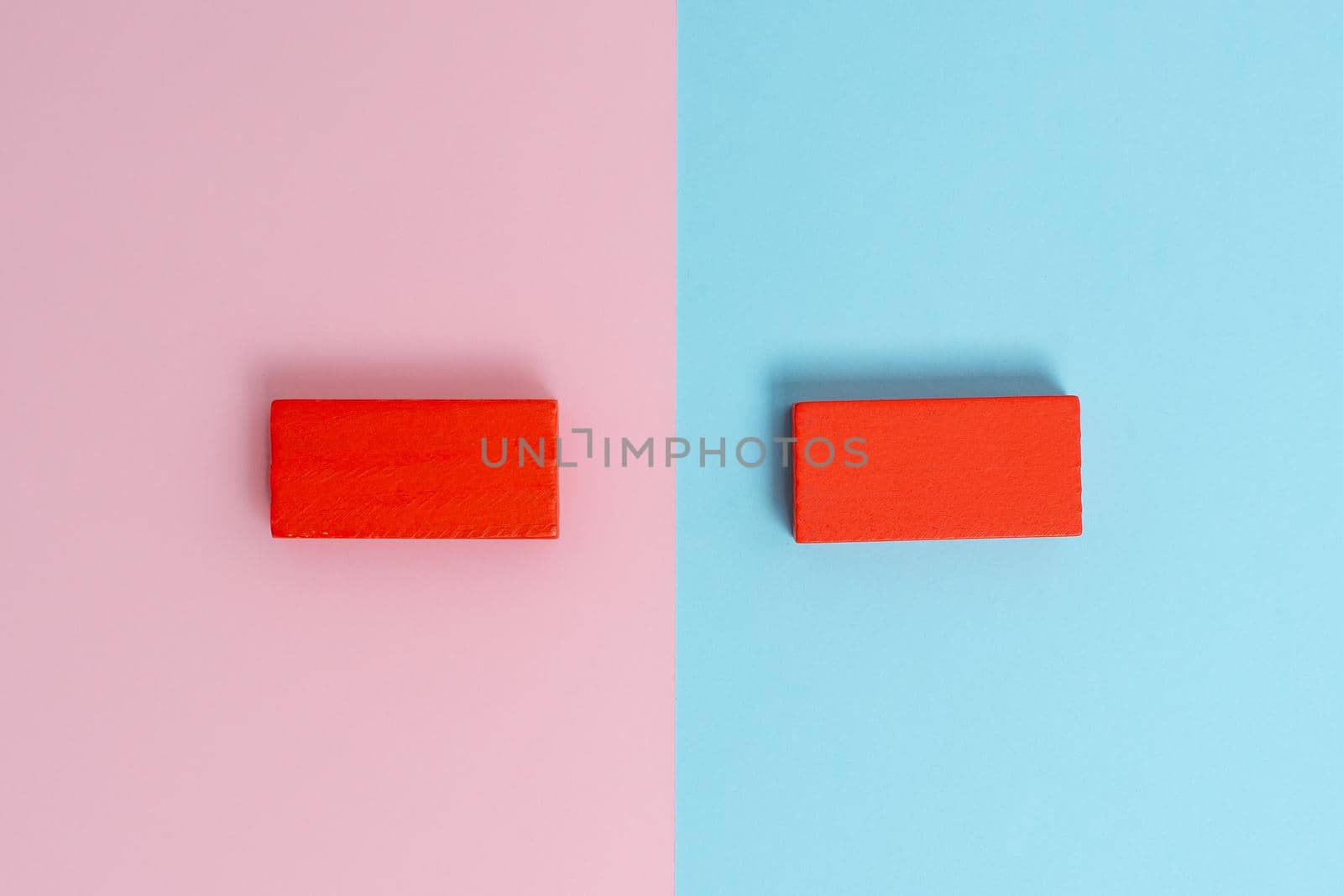 Two Objects Arranged Facing Inward Outward On a Separated Coloured Background