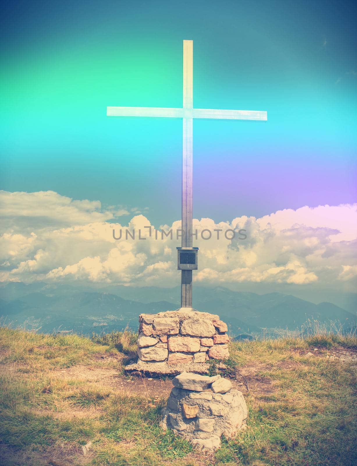 Wooden summit cross in the Austrian Alps mountains. Cloudy weather.  Abstract.