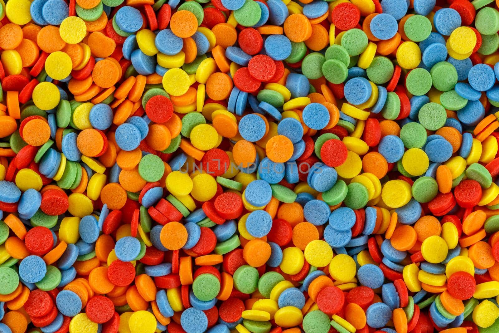 Rainbow sugar sprinkle dots, decoration for cake and bakery texture. Colorful Easter background. Confectionery multicolored decorative topping.