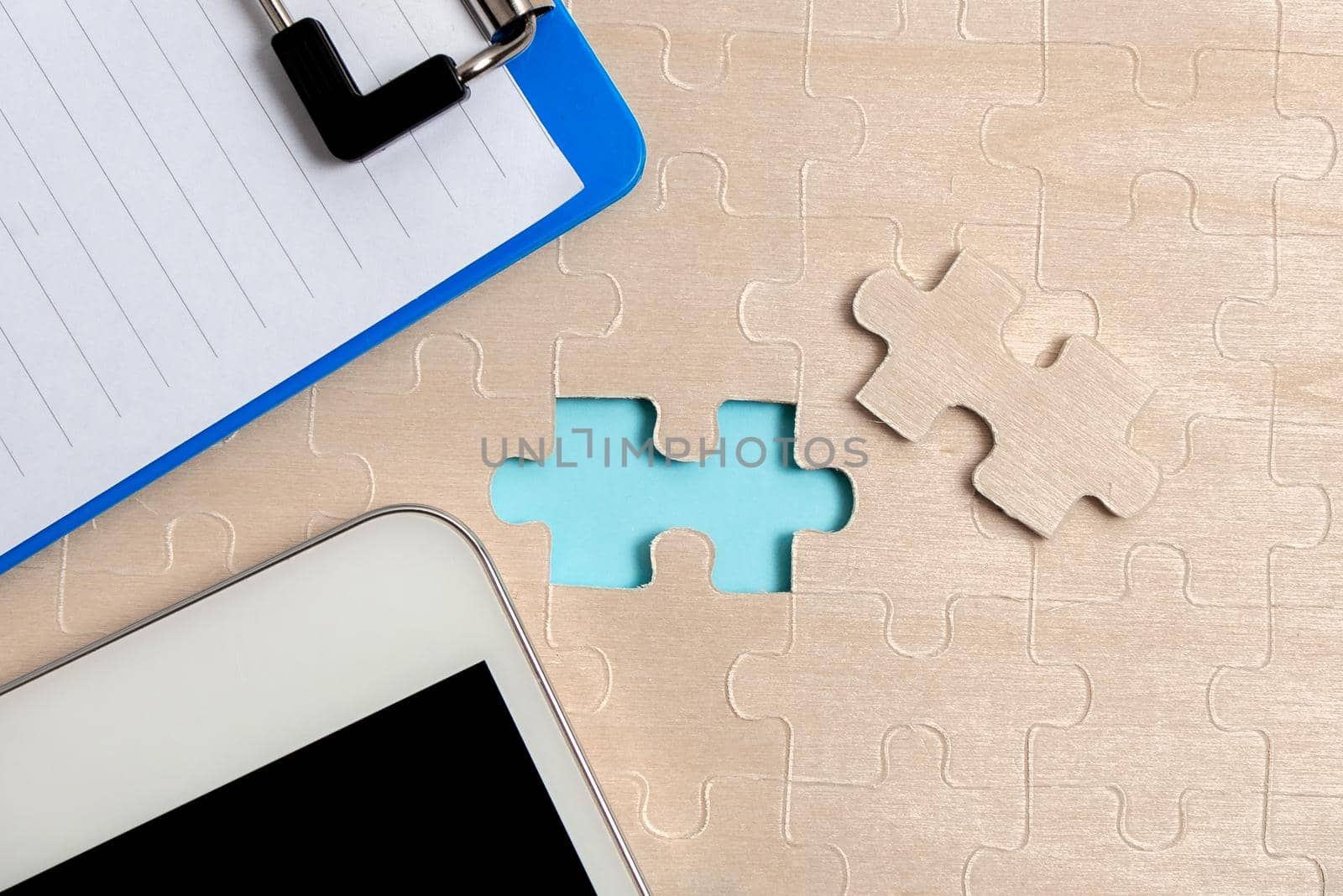 Building An Unfinished White Jigsaw Pattern Puzzle With Missing Last Piece