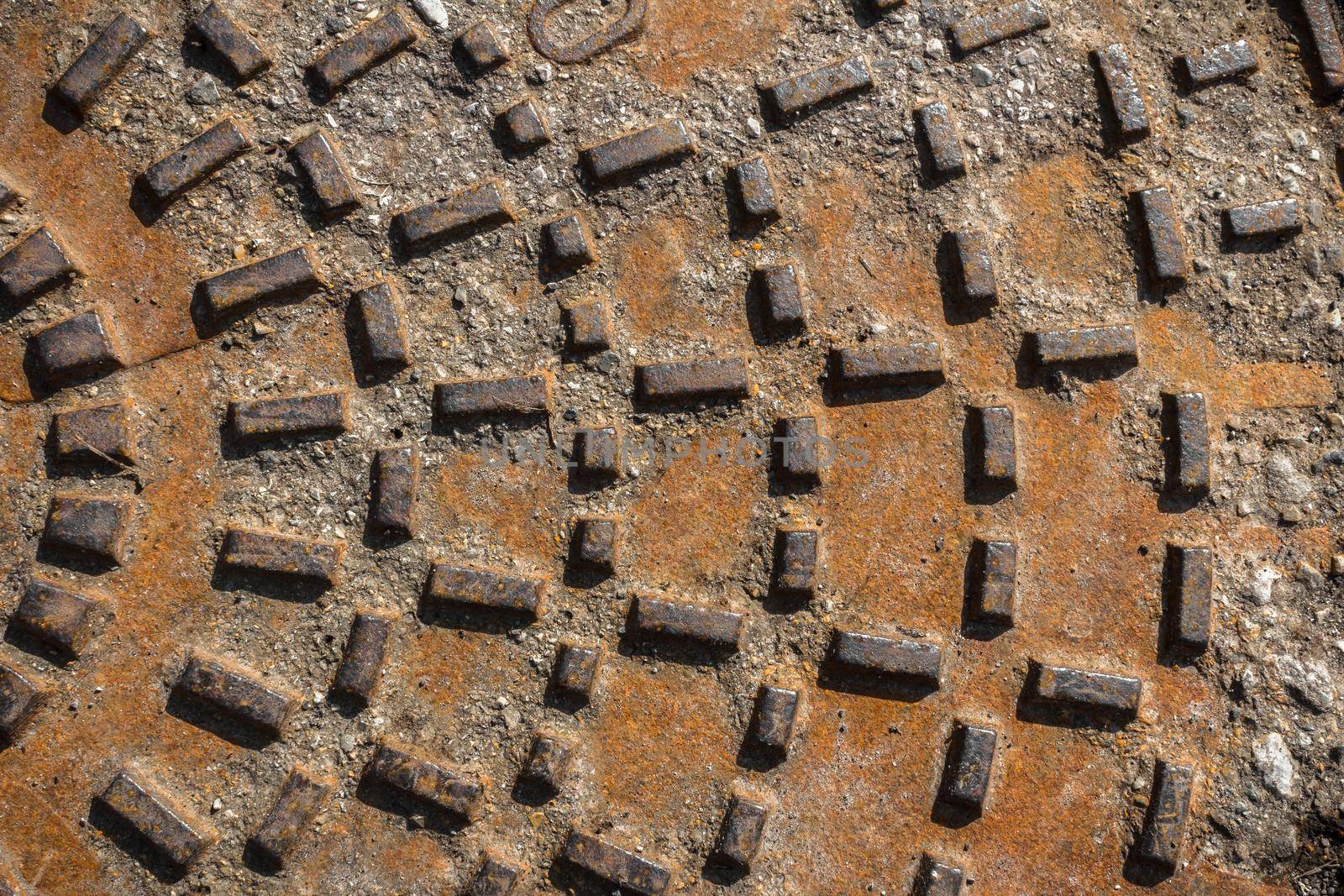 Rusty sewer manhole cover by germanopoli
