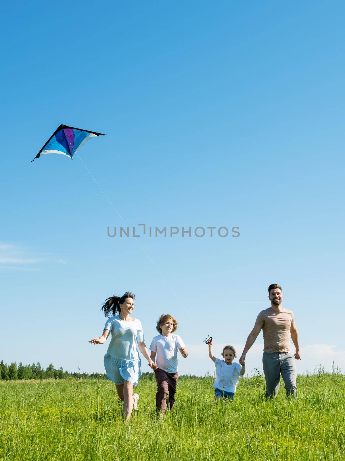 Happy family fly a kite by ALotOfPeople